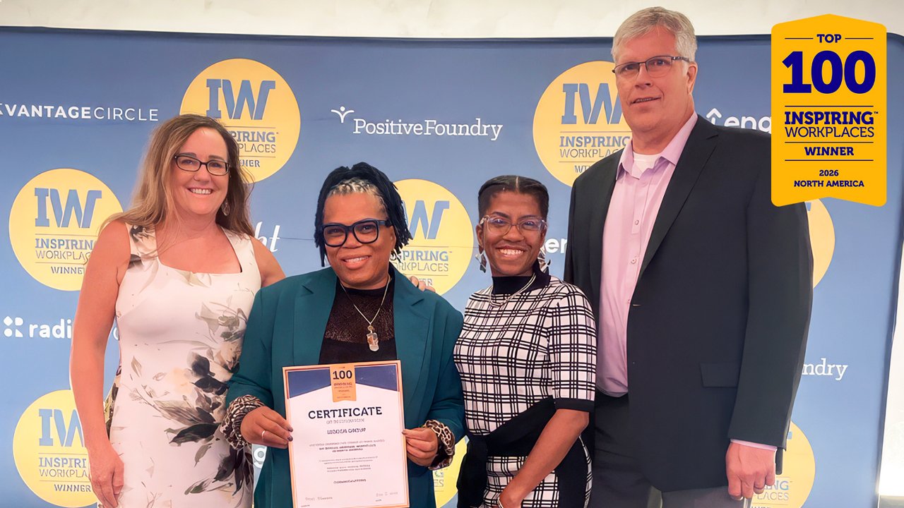 A group of Ledcor employees posing with the Most Inspiring Workplaces award