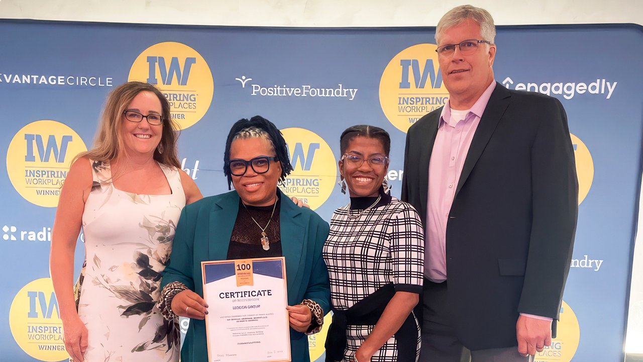 A group of Ledcor employees posing with the Most Inspiring Workplaces award