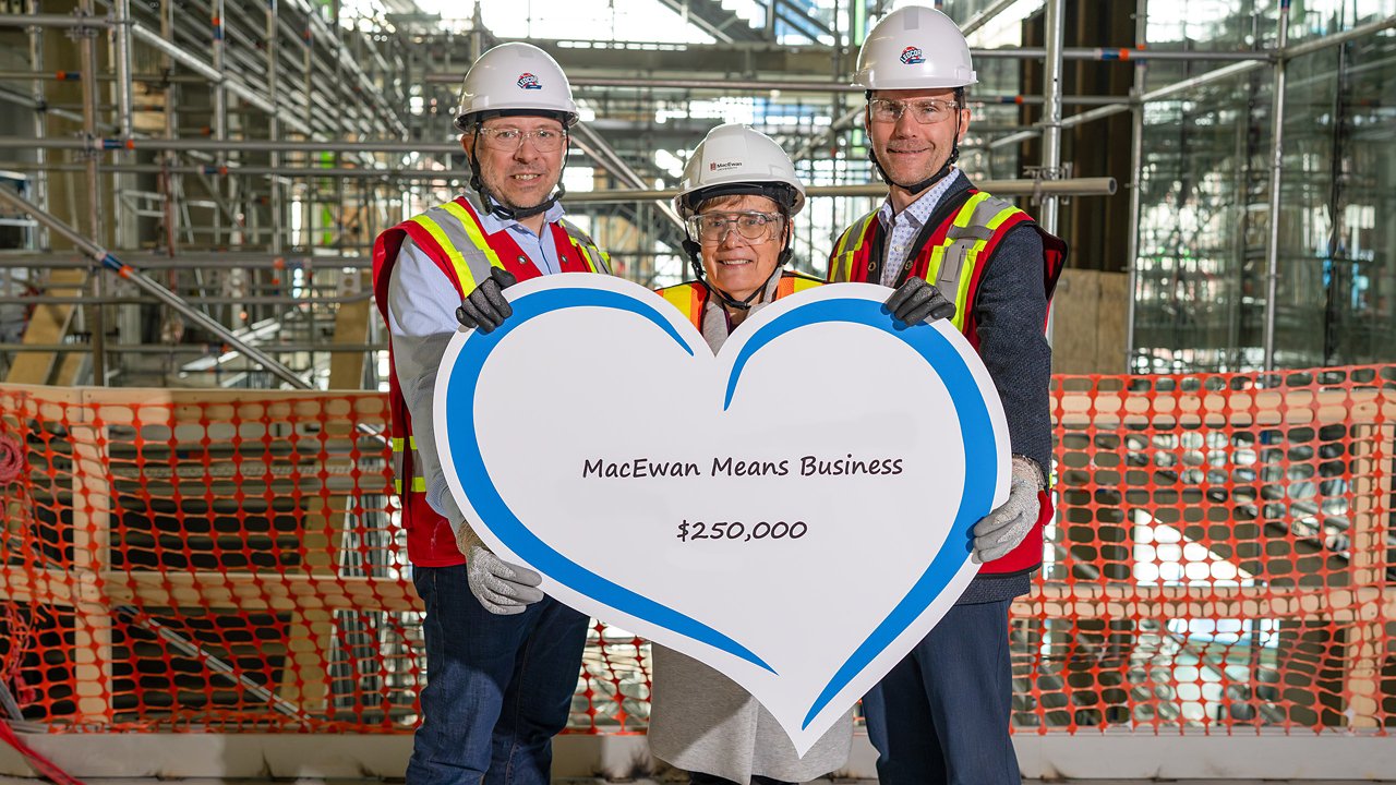 Ledcor representatives posing with a large MacEwan Donation presentation cheque