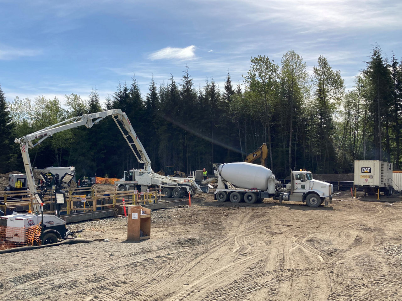 Vehicles at work and pipes being installed at a project site